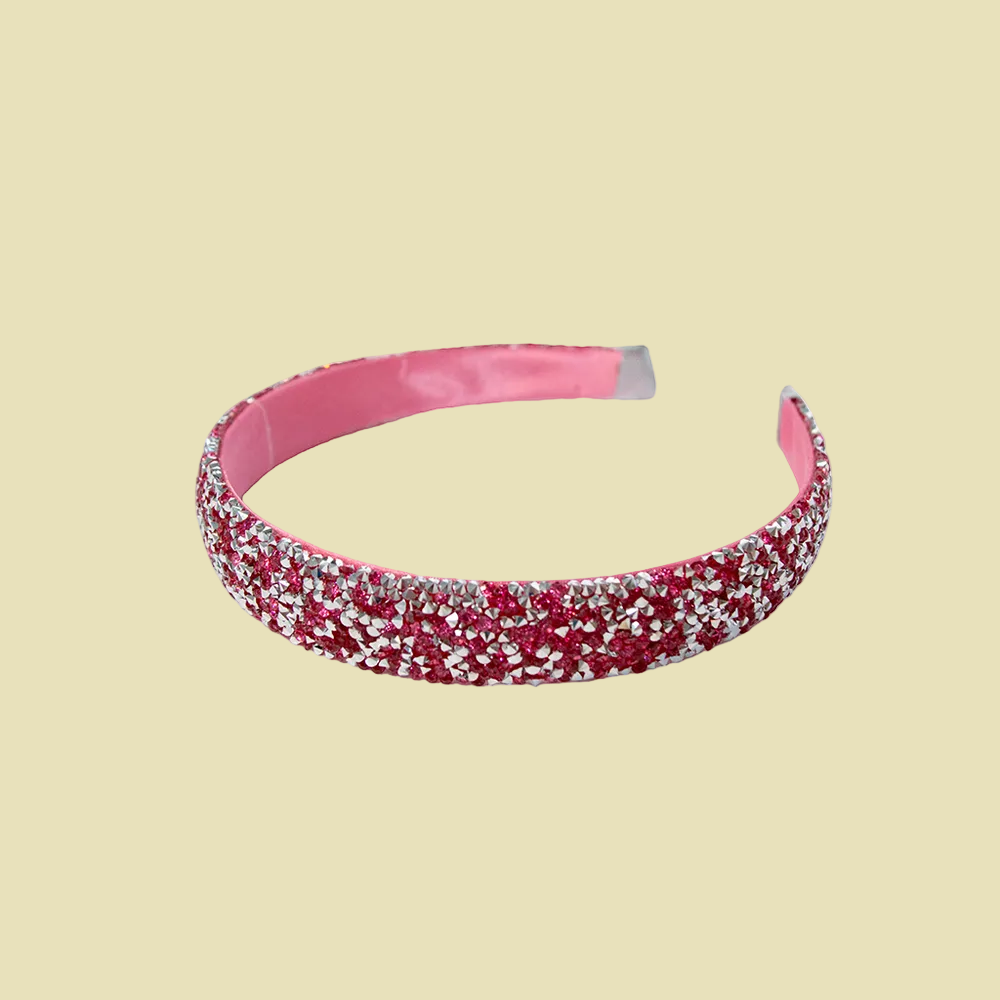 Two glittery headbands, one pink and one rose gold, on a white background.