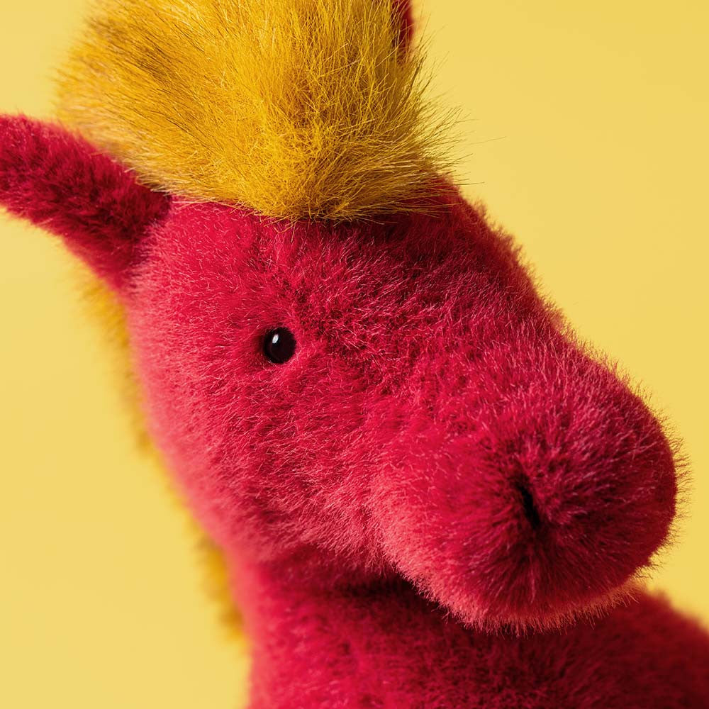 Plush horse with red body and yellow mane and hooves
