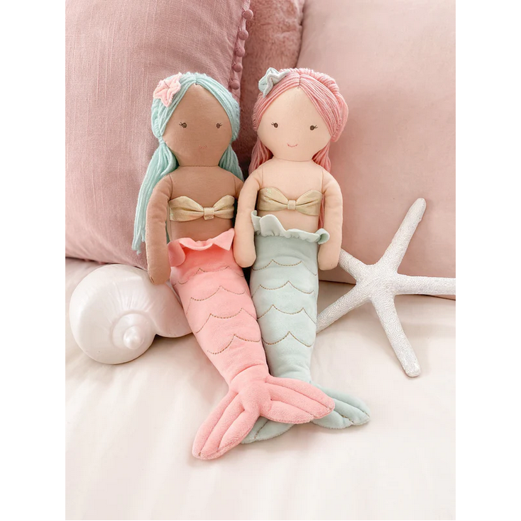 Mermaid plush toy with pink hair and a green tail on a white background