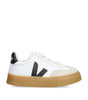White sneaker with black logo and brown sole on a white background