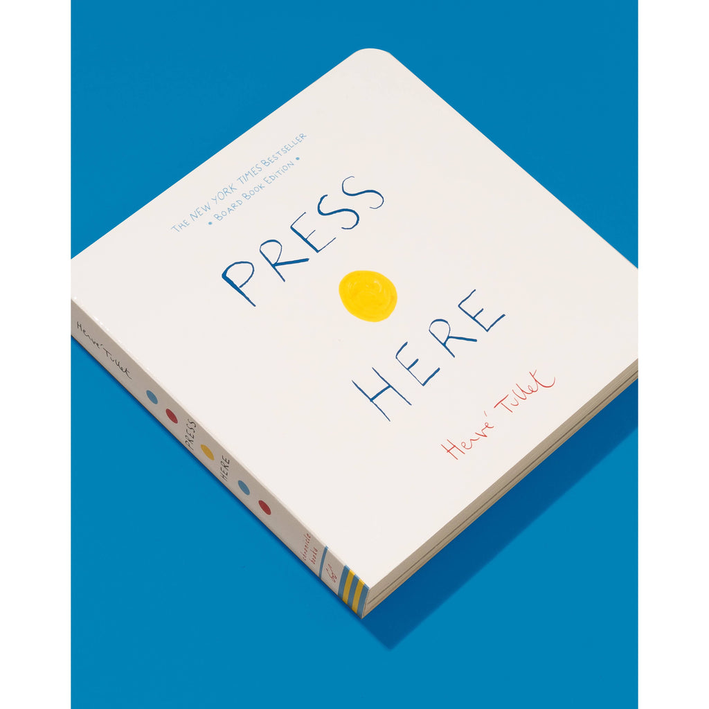 Board book cover of 'Press Here' with blue text and a yellow circle on a white background.