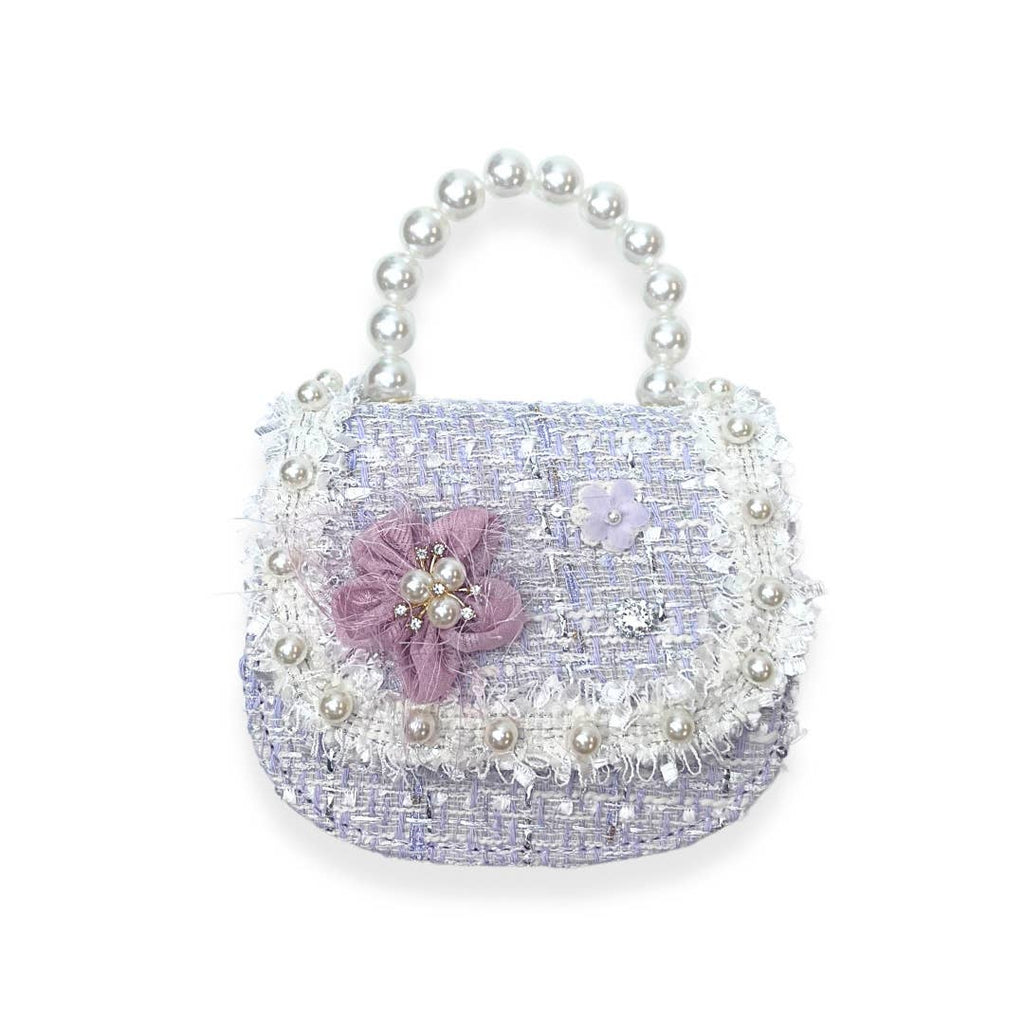 Small handbag with pearl handle and floral decorations on a white background