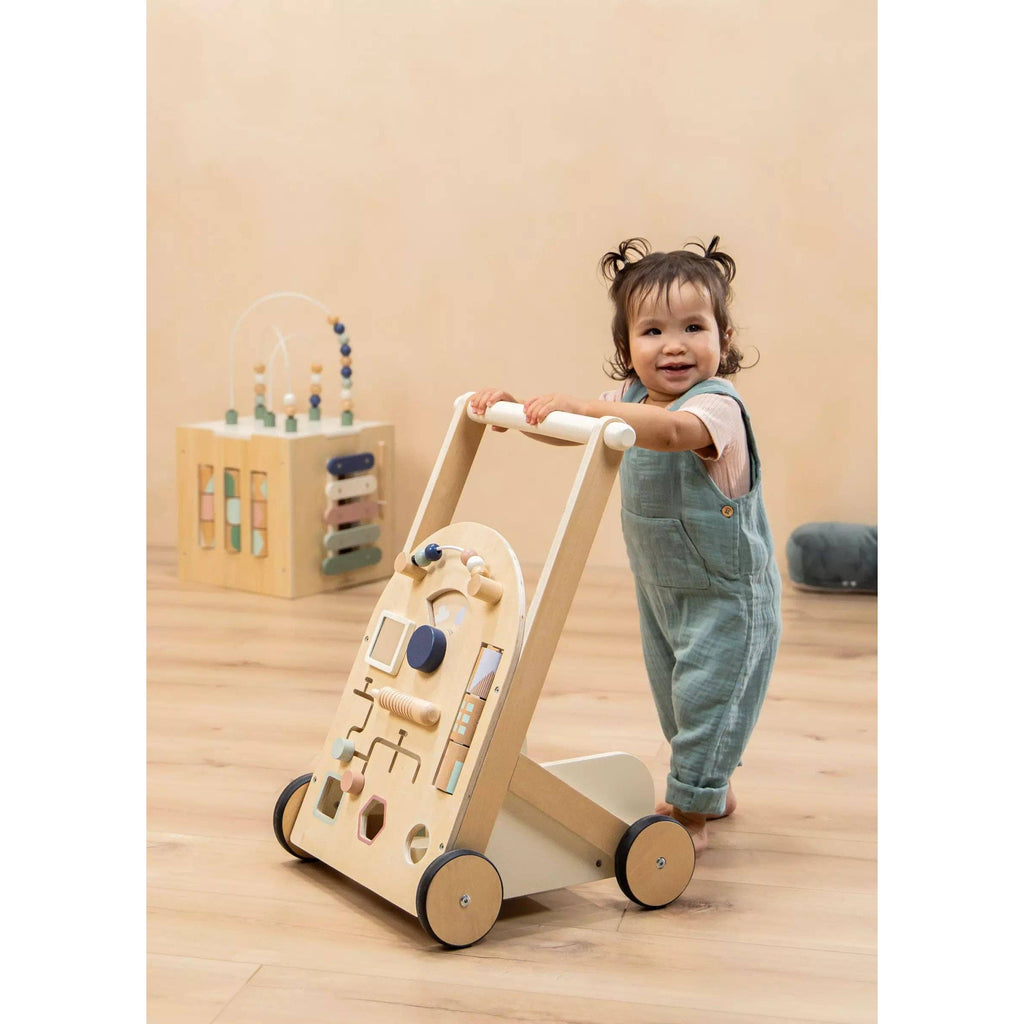 Wooden activity walker with various shapes and toys on a beige background
