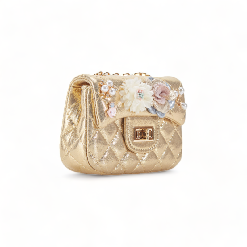 Gold glitter handbag with floral and pearl embellishments on a white background