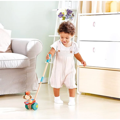 Colorful wooden toy with wheels and a stick on a white background