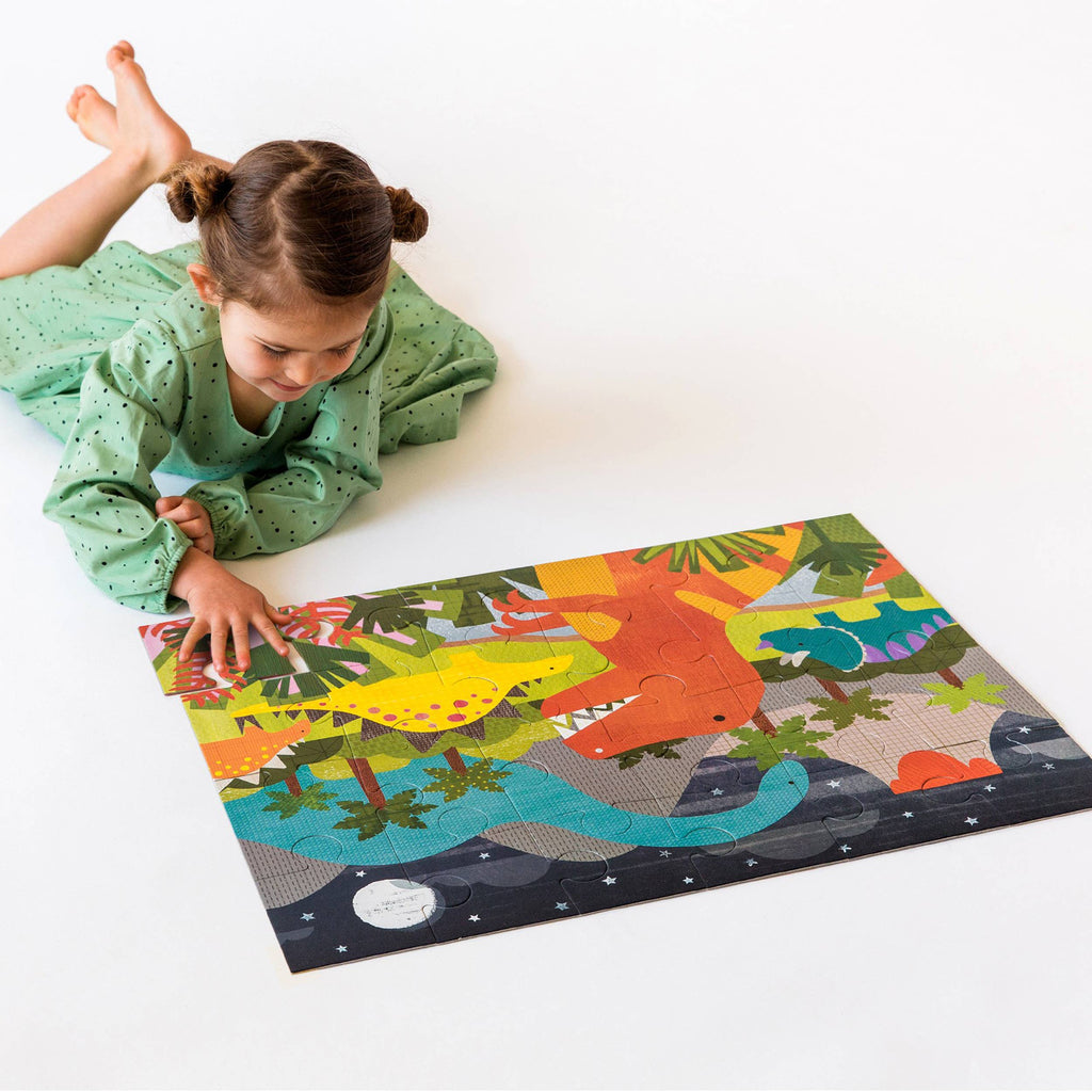 Floor puzzle packaging with colorful dinosaur illustrations on a white background