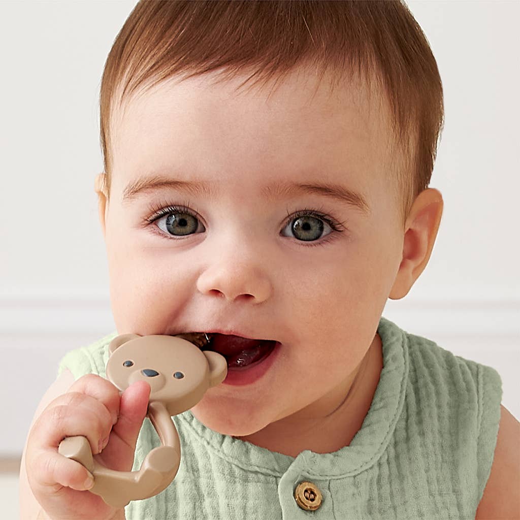 Beige bear-shaped teething ring with textured top on a white background