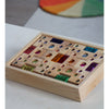 Wooden box with colorful geams on a light surface