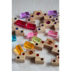 Colorful wooden blocks with embedded beads on a light background