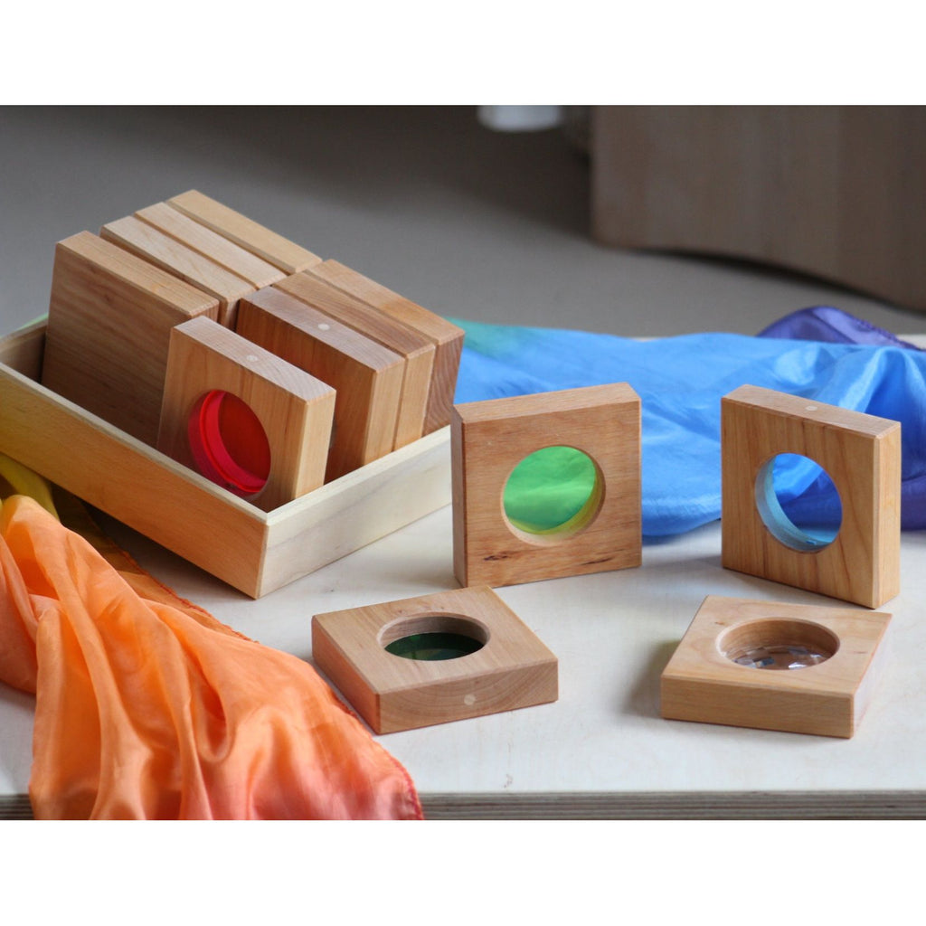 Wooden educational blocks with colorful interiors on a table