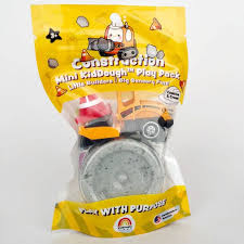 Toy construction vehicles and a package on a green background