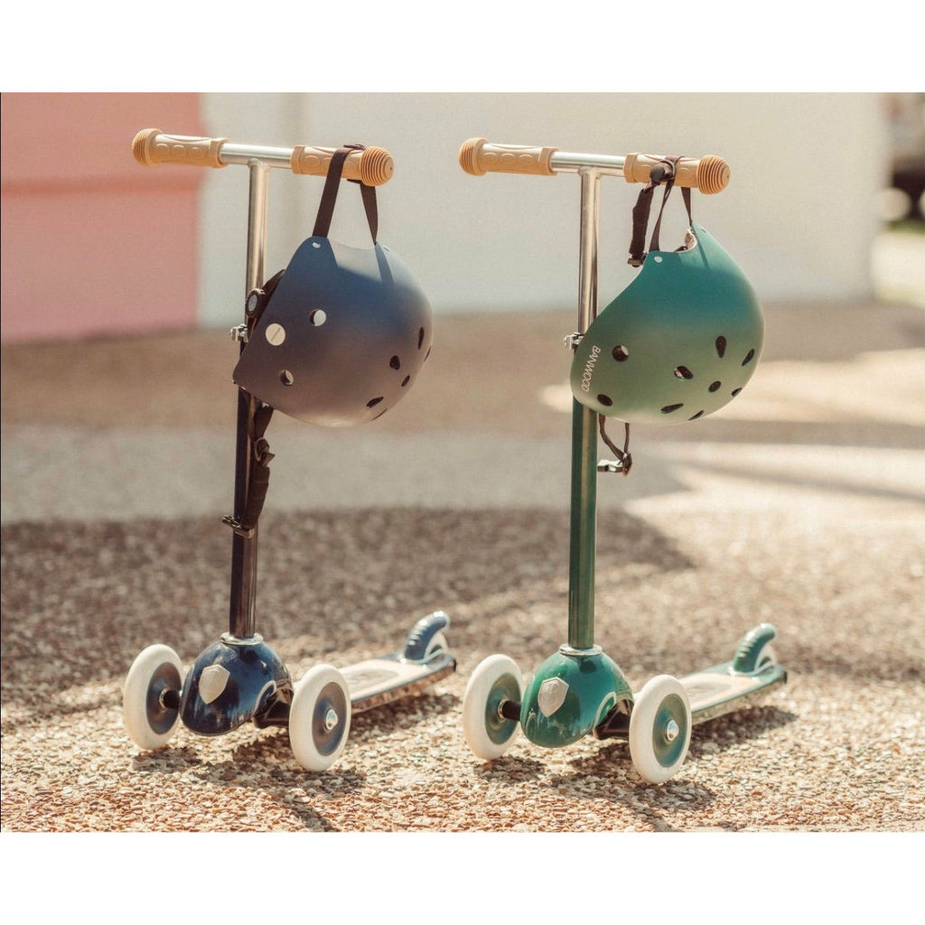 A navy blue Banwood children's scooter with an adjustable T-bar handle and a wide wooden deck with a black rubber grip tape.